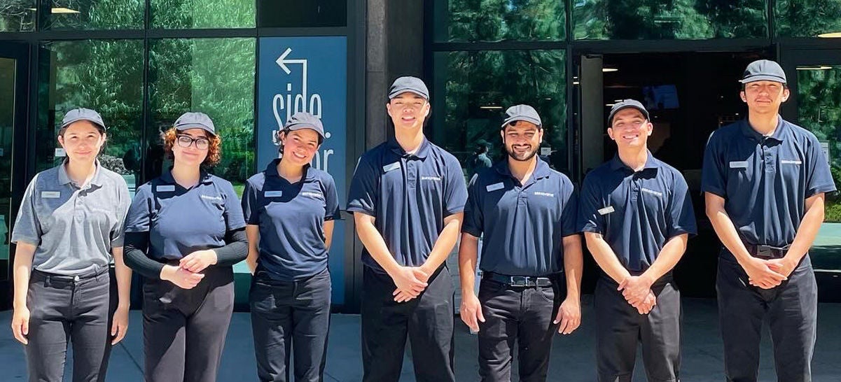 A group of employees smiling in front of Brandywine.