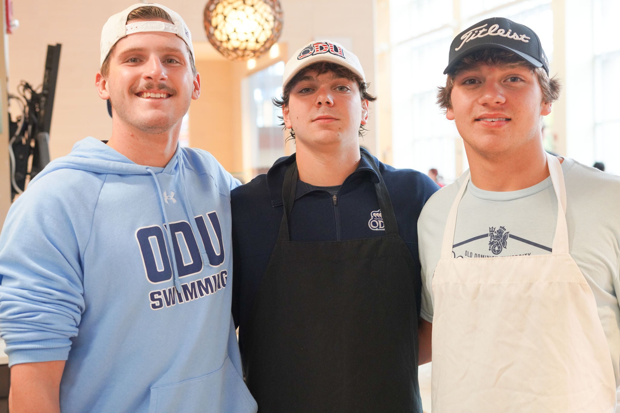 Bowls and plates of food on a blue tablecloth.