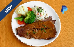 Braised Beef Brisket with potato salad and vegetables.