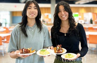 Two students smiling