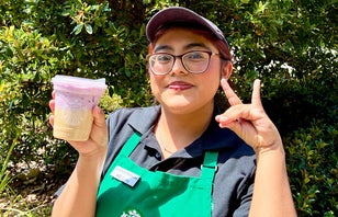 A smiling UC Irvine Dining employee in their uniform.