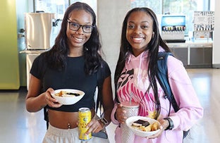 Two students smiling