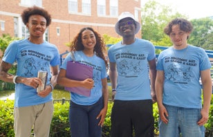 Two students enjoying Starbucks in the garden at Webb Center.
