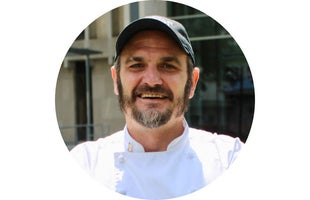 Chef with hat crossing arms