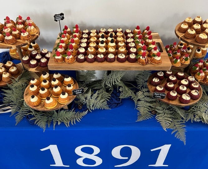 Catering table covered with delicious individual desserts.