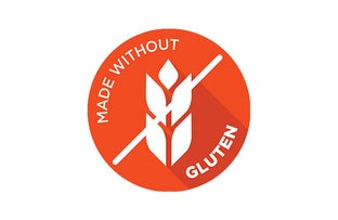 A circular vibrant orange icon displaying a white wheat stalk crossed out by a diagonal slash, with the text "MADE WITHOUT" along the upper left edge and "GLUTEN" along the lower right edge.