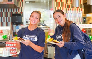 Two students with plates of food in Broderick Dining Commons.
