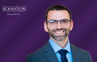 The University of Scranton Dining Services logo with image of Jay Racavich