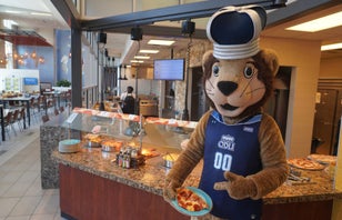 Big Blue getting pizza inside Broderick Dining Commons.